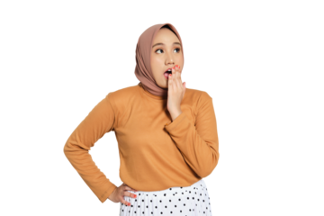 Surprised young Muslim woman in hijab covering mouth with hand isolated on transparent background