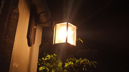 Decorative street lights glowing at night, creating a warm, peaceful atmosphere. Ideal for urban...