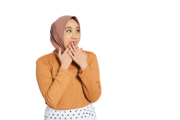 Surprised young Muslim woman in hijab covering mouth with both hands and looking away isolated on transparent background