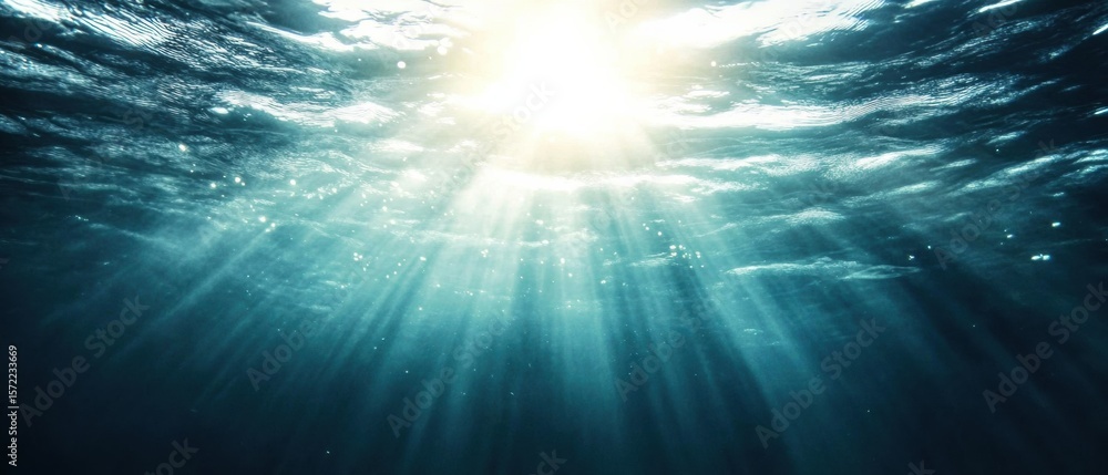 Aufkleber sunlight creating wave-like patterns in serene underwater scene with deep beams through clear blue o