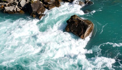 Turquoise rapids around a dark rock