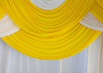 The curtains are white and yellow in wavy patterns.