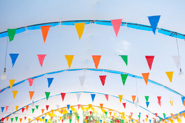 Colorful triangular flags hang along a row.