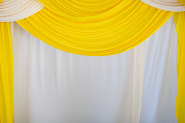 The curtains are white and yellow in wavy patterns.