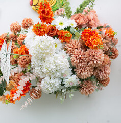 White and orange flowers on a white background.