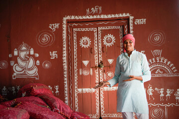 young indian farmer giving happy expression