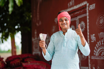 happy indian farmer showing money