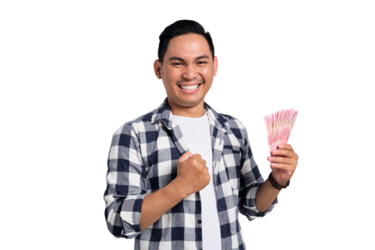 Happy young man in checkered shirt holding Indonesian rupiah money and celebrating success with clenched fist isolated on transparent background - Powered by Adobe