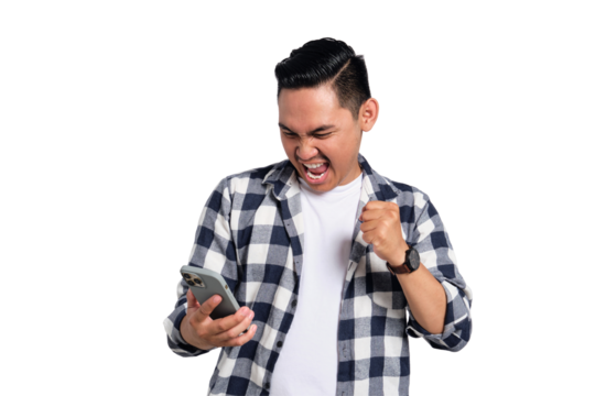 Excited young man in checkered shirt clenching fist while looking at smartphone screen with happy expression isolated on transparent background