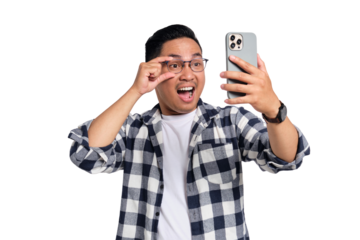 Surprised young man in glasses looking at smartphone screen with wide eyes and expressive face isolated on transparent background