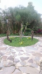 A serene stone path winds through a lush summer garden