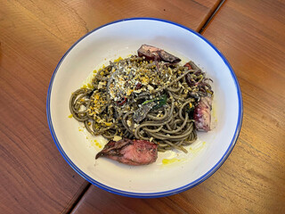 Squid ink spaghetti in white dishes 