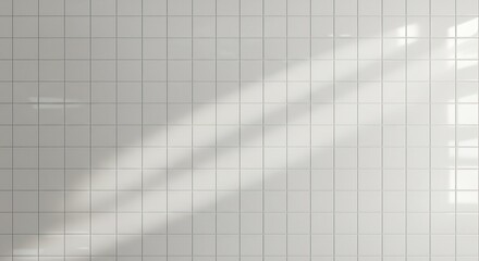 Clean white square tiled wall with diagonal sunlight and shadow interplay