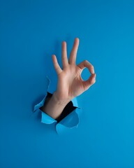 human hand making an OK blue background
