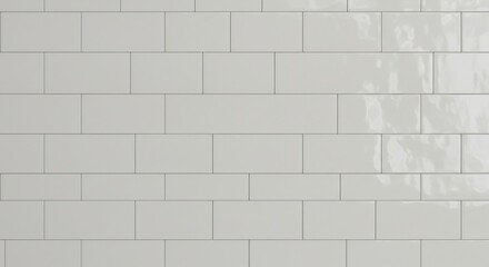 Closeup of a wall featuring light grey rectangular tiles arranged in a staggered pattern with dark grout lines