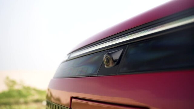 Closeup shot of car front grill with camera.