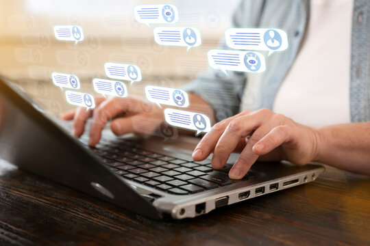 Engaging in online conversation through a laptop with chat notifications appearing on the screen