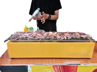 Street food vendor grilling squid satay with a blowtorch.
Midsection of man preparing food on barbecue grill. 
