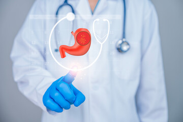 Doctor in medical uniform pointing at a digital hologram of a human stomach, representing digestive...