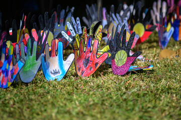 Paper hands decorated with Indigenous Australian messages.