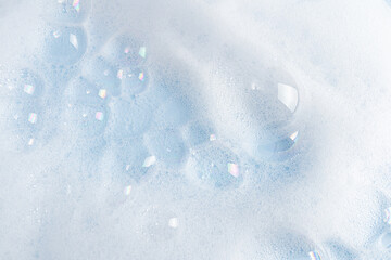 There are many beautiful transparent bubbles on the foam surface of shower shampoo, body gel, soap. Abstract cosmetic background.