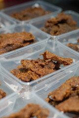Golden brown, crispy beef pieces packed in clear plastic containers