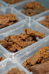 Close up of golden brown, crispy beef pieces packed in clear plastic containers
