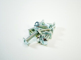 Close up on several silver machine screws with square nuts ready for assembly or industrial...