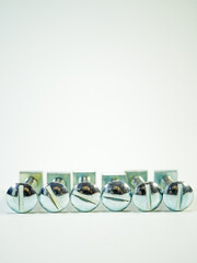 Slotted round head machine screws and square nuts neatly aligned for a hardware or industrial...