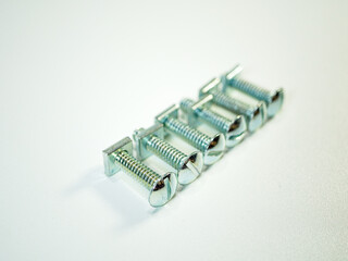 Aligned carriage bolts showcase fastening hardware used in construction and machinery applications,...