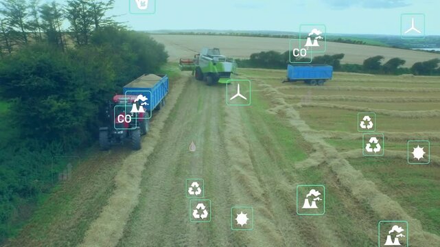 Drone camera opening field showing combine unloading grain into trailer with icons monitoring yield