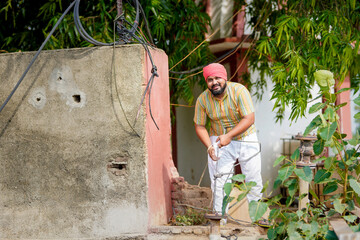 happy farmer with water pipe or water resources at agriculture field