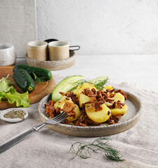 Delicious fried chanterelles with new potatoes on ceramic plate, copy space