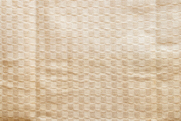 Beige fabric background with geometric checkered pattern, textile texture for interior