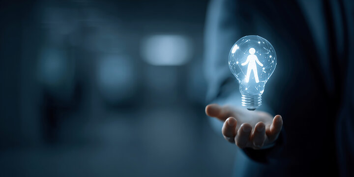 a businessman in a dark suit holding a glowing lightbulb with a human icon inside, futuristic technology concept, professional background, dark corporate office - Powered by Adobe