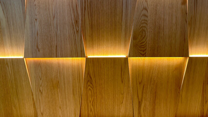 Wooden Wall Panel with Trapezoid Pattern and Warm Yellow Lighting