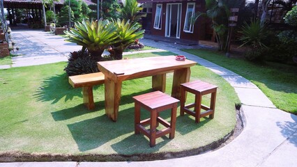 Set up a layout of wooden tables and chairs for an outdoor restaurant or cafe
