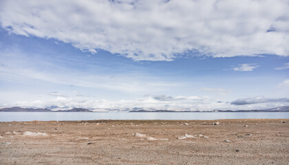 Lake Karakul in the Pamir mountains in the Tien Shan against the background of high rocky peaks, morning panorama of the lake for the background