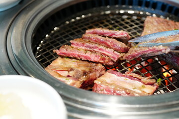 Korean BBQ with Raw Beef Short Ribs Grilled on Charcoal at Local Galbi Restaurant
