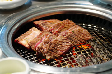 Korean BBQ with Raw Beef Short Ribs Grilled on Charcoal at Local Galbi Restaurant