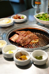 Korean BBQ with Raw Beef Short Ribs Grilled on Charcoal at Local Galbi Restaurant