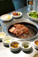 Korean BBQ with Raw Beef Short Ribs Grilled on Charcoal at Local Galbi Restaurant