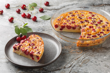slice of cherry pie clafoutis simple summer dessert close-up in a plate on a table. Horizontal