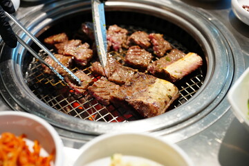 Korean BBQ with Raw Beef Short Ribs Grilled on Charcoal at Local Galbi Restaurant