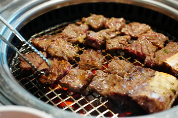 Korean BBQ with Raw Beef Short Ribs Grilled on Charcoal at Local Galbi Restaurant