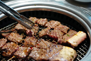 Korean BBQ with Raw Beef Short Ribs Grilled on Charcoal at Local Galbi Restaurant