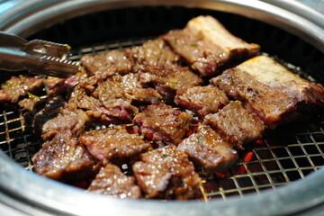Korean BBQ with Raw Beef Short Ribs Grilled on Charcoal at Local Galbi Restaurant