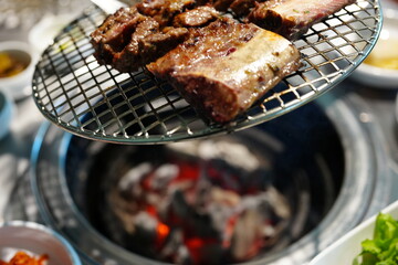 Korean BBQ with Raw Beef Short Ribs Grilled on Charcoal at Local Galbi Restaurant