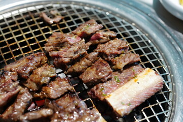 Korean BBQ with Raw Beef Short Ribs Grilled on Charcoal at Local Galbi Restaurant