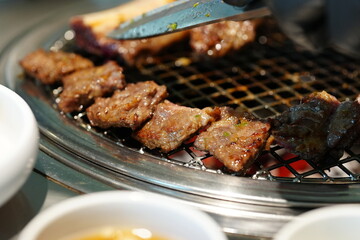 Korean BBQ with Raw Beef Short Ribs Grilled on Charcoal at Local Galbi Restaurant